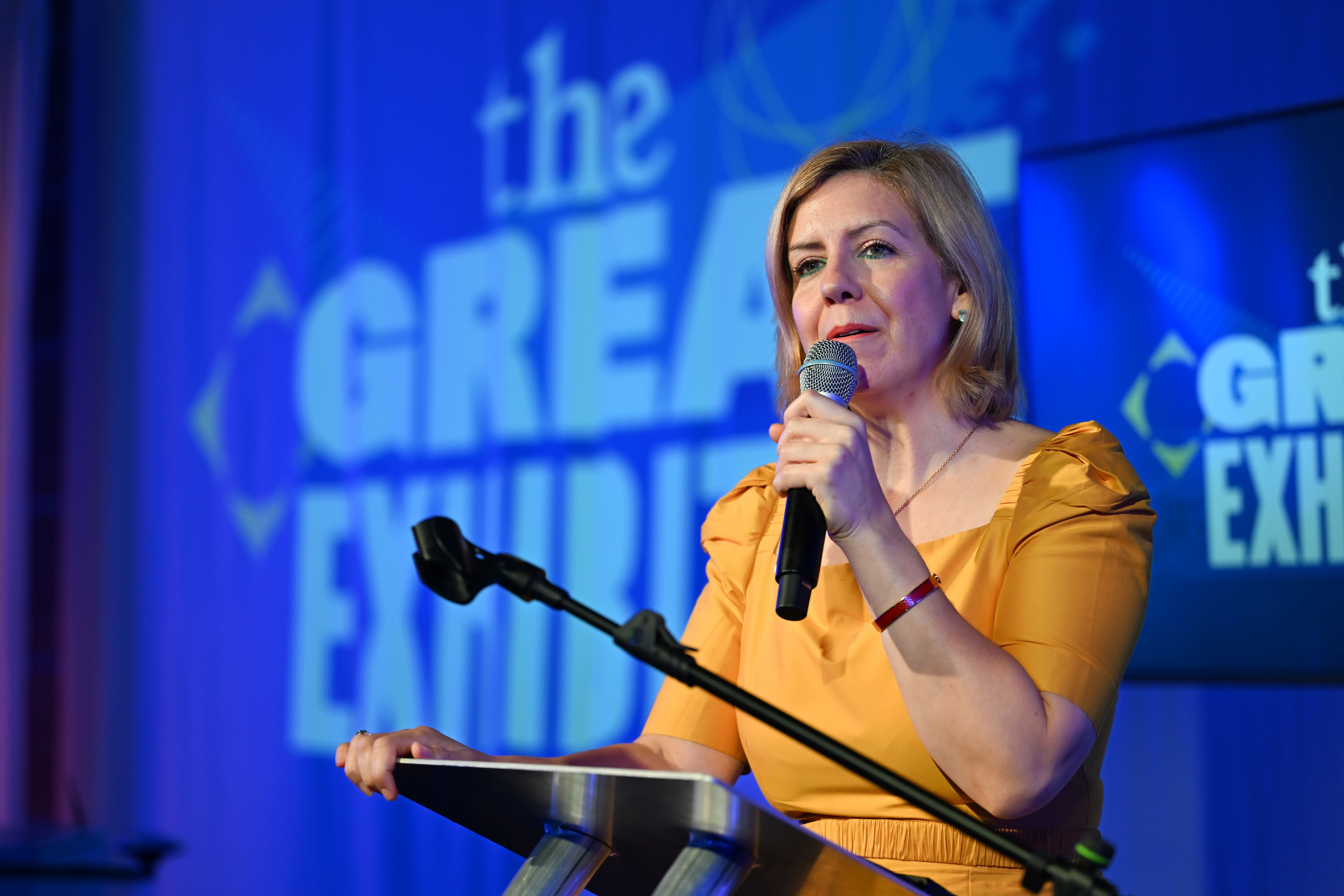 Andrea stood at the podium giving a speech