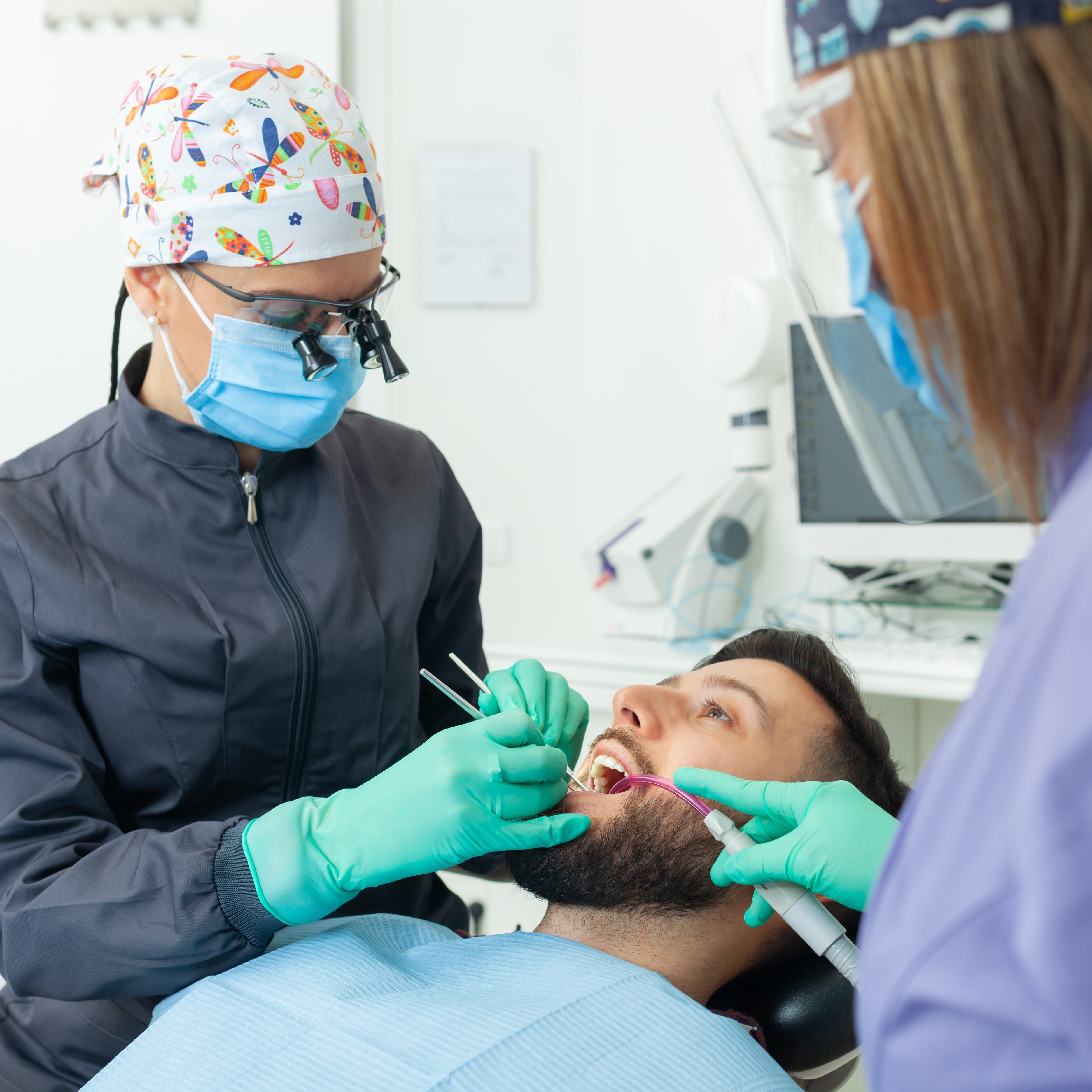 Dentist and dental nurse with patient