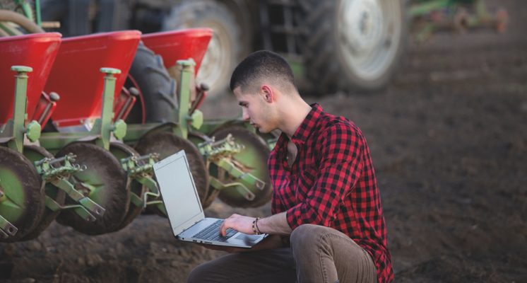 A young farmer using modern farming techniques